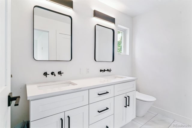 2280 W 42nd Ave, Denver, CO 80211 - bathroom featuring toilet, double vanity, and baseboards