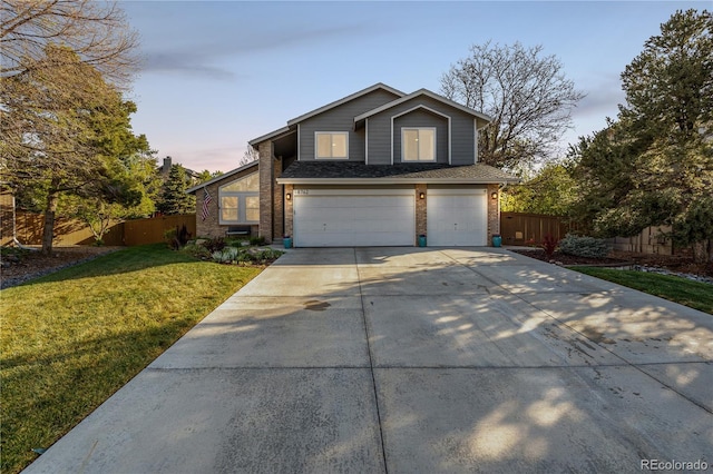 view of front of property with driveway, brick siding, fence, a front lawn, and an attached garage