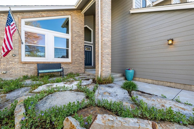 doorway to property with brick siding