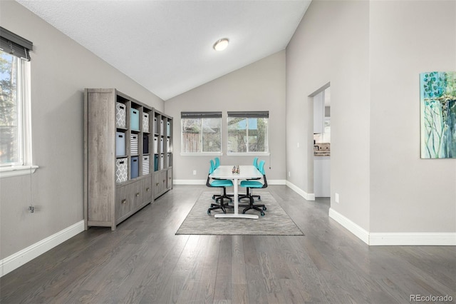 unfurnished office featuring plenty of natural light, baseboards, and wood finished floors