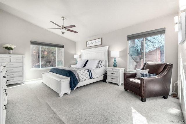 bedroom featuring multiple windows, vaulted ceiling, and light carpet