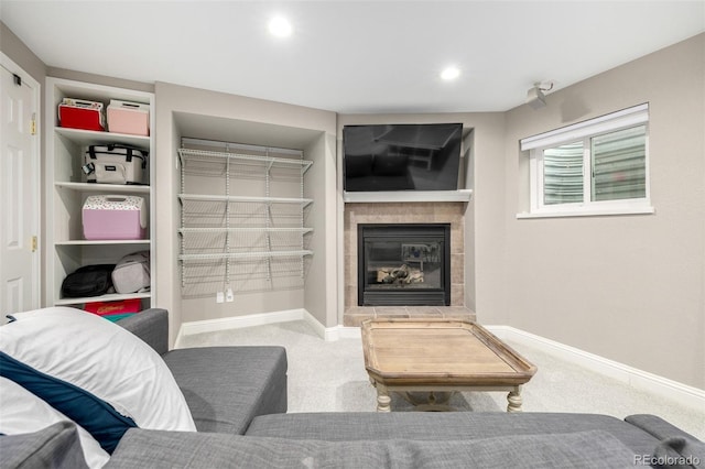 carpeted living room with a tiled fireplace, baseboards, and recessed lighting