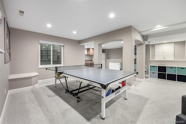 playroom featuring arched walkways, baseboards, recessed lighting, and light colored carpet