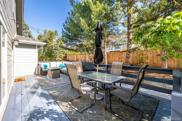 view of patio / terrace with outdoor dining area, a fenced backyard, an outdoor hangout area, and a deck