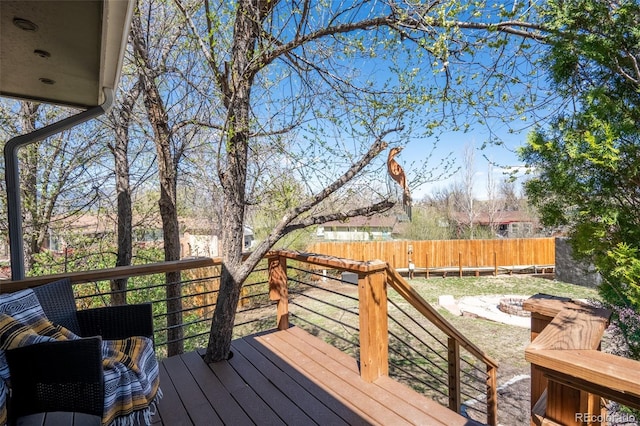 wooden deck featuring fence and an outdoor fire pit