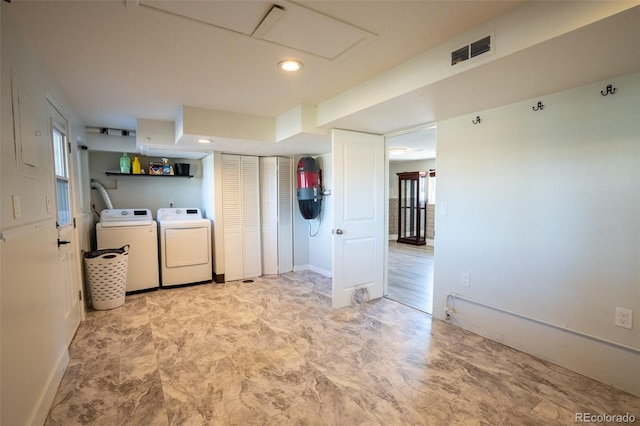 laundry area featuring baseboards, visible vents, washer and dryer, and laundry area
