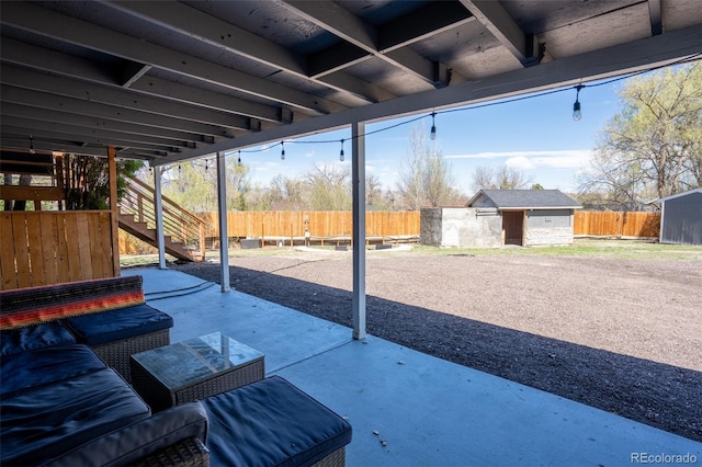view of patio with fence, an outdoor structure, a storage shed, and stairs