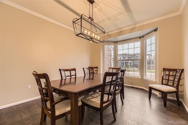 dining room with crown molding, baseboards, dark wood-style flooring, and a chandelier
