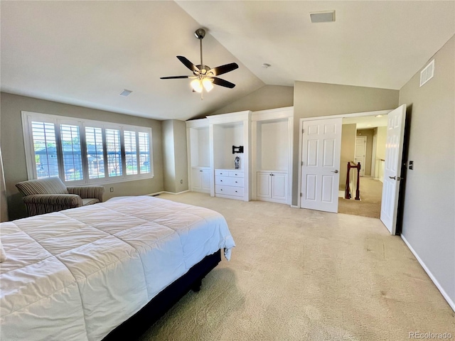 bedroom with vaulted ceiling, light colored carpet, and a ceiling fan
