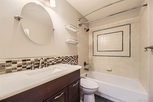 bathroom featuring washtub / shower combination, vanity, toilet, and tile walls