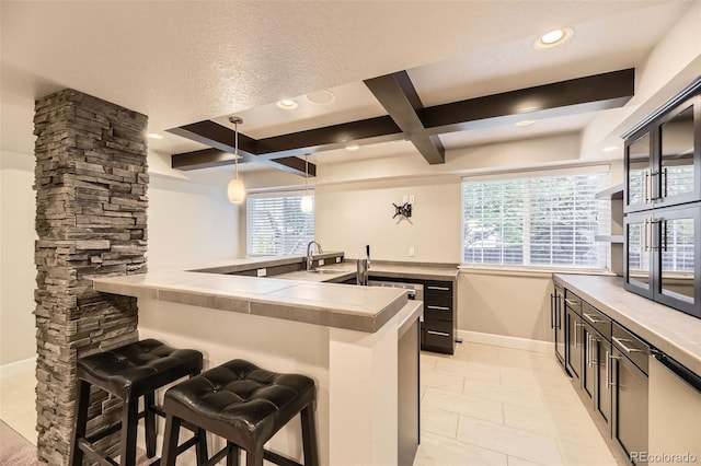 kitchen with a breakfast bar, baseboards, coffered ceiling, recessed lighting, and beamed ceiling