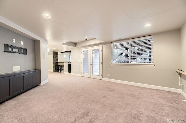 unfurnished living room with light carpet, baseboards, and recessed lighting