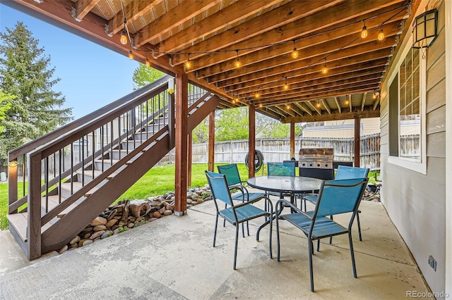 view of patio with stairway, outdoor dining area, and grilling area