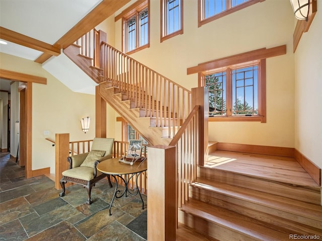 3395 Timbergate Trl, Evergreen, CO 80439 - stairs featuring stone tile flooring and a towering ceiling