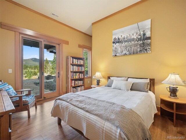 3395 Timbergate Trl, Evergreen, CO 80439 - bedroom with access to outside, crown molding, and wood finished floors