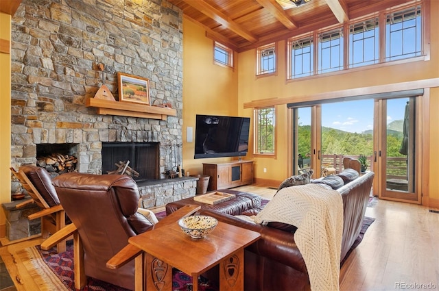 3395 Timbergate Trl, Evergreen, CO 80439 - living area with a wood ceiling with exposed beams, hardwood / wood-style flooring, a fireplace, plenty of natural light, and a high ceiling