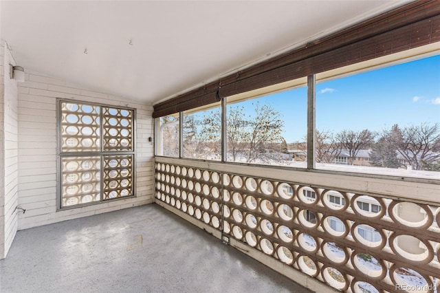 unfurnished sunroom featuring lofted ceiling