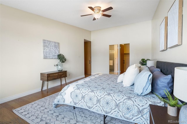 bedroom featuring ceiling fan, connected bathroom, and hardwood / wood-style floors