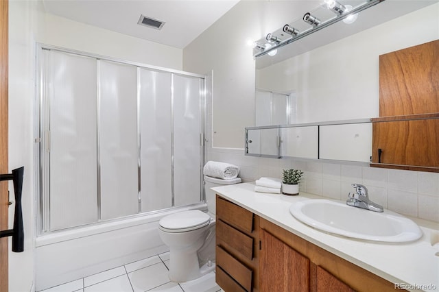 full bathroom featuring enclosed tub / shower combo, toilet, tile patterned floors, and vanity