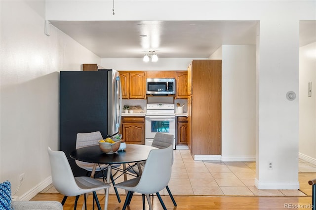 kitchen with light tile patterned floors and white electric range oven