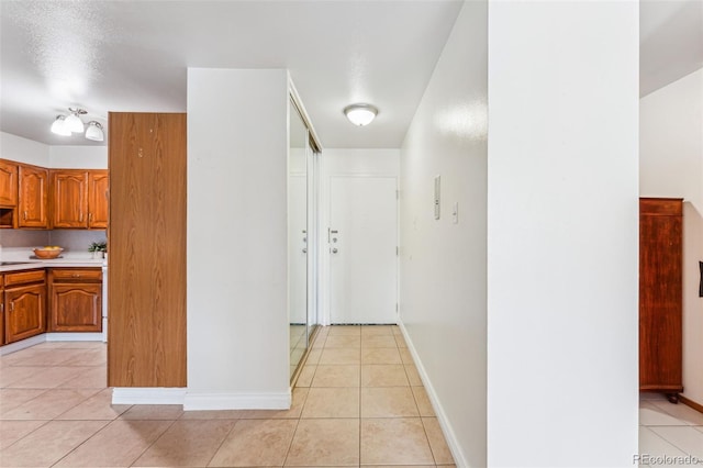 hallway featuring light tile patterned floors