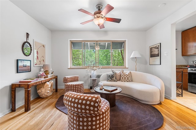 2100 N Franklin St Unit 5, Denver, CO 80205 - living room featuring light wood finished floors, ceiling fan, and radiator heating unit