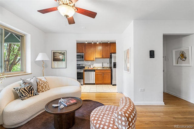 2100 N Franklin St Unit 5, Denver, CO 80205 - living room with light wood finished floors and a ceiling fan