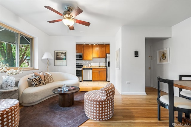 2100 N Franklin St Unit 5, Denver, CO 80205 - living room with light wood finished floors and ceiling fan
