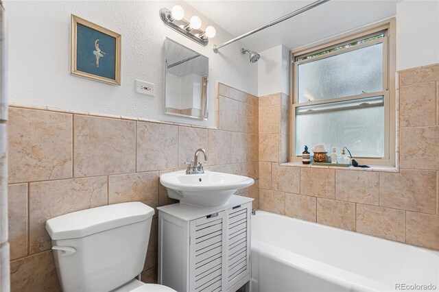2100 N Franklin St Unit 5, Denver, CO 80205 - bathroom with tile walls, a bath, and vanity