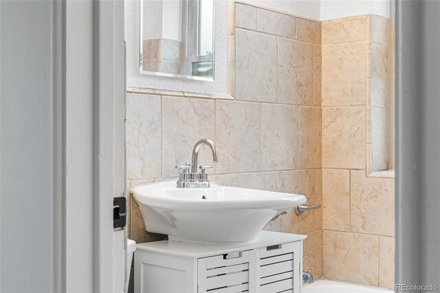2100 N Franklin St Unit 5, Denver, CO 80205 - bathroom with tile walls, vanity, and bathtub / shower combination