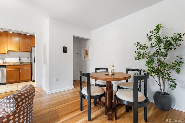 2100 N Franklin St Unit 5, Denver, CO 80205 - dining area featuring light wood finished floors and baseboards