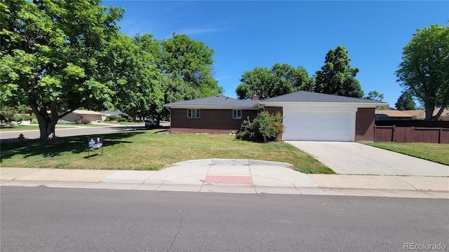 ranch-style home featuring a garage and a front lawn