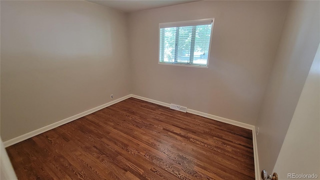 spare room featuring dark hardwood / wood-style floors