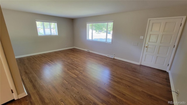 unfurnished room featuring dark hardwood / wood-style floors