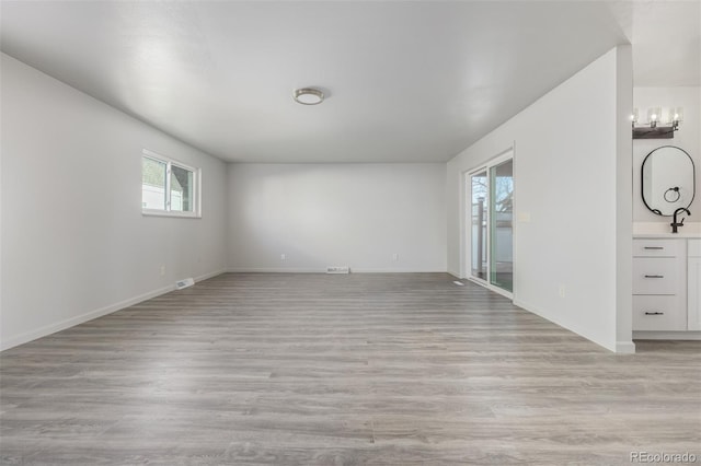 unfurnished room with a wealth of natural light and light hardwood / wood-style floors