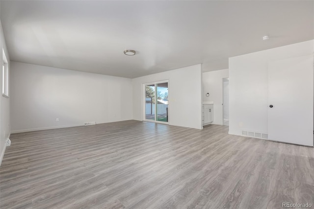 unfurnished living room with light wood-type flooring