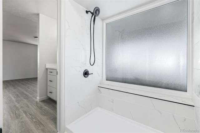 bathroom featuring a shower, vanity, and hardwood / wood-style flooring