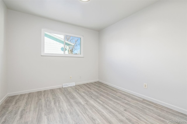 spare room featuring light hardwood / wood-style flooring