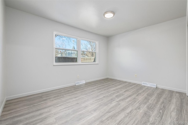 spare room featuring light wood-type flooring