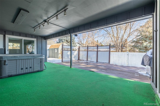 unfurnished sunroom with rail lighting