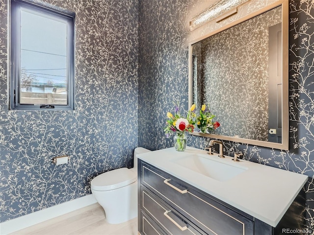 bathroom with vanity, hardwood / wood-style floors, and toilet