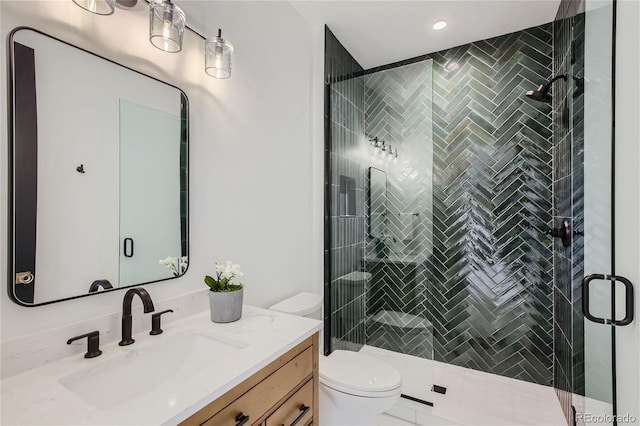 bathroom with vanity, toilet, and a shower with shower door