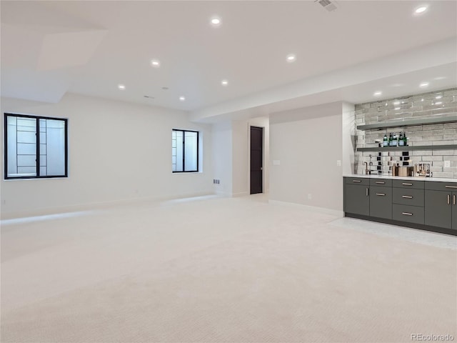 bar featuring tasteful backsplash and light colored carpet