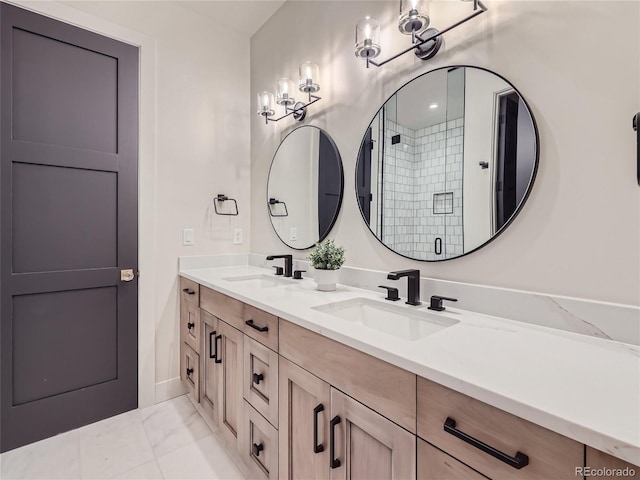 bathroom with a shower with door and vanity