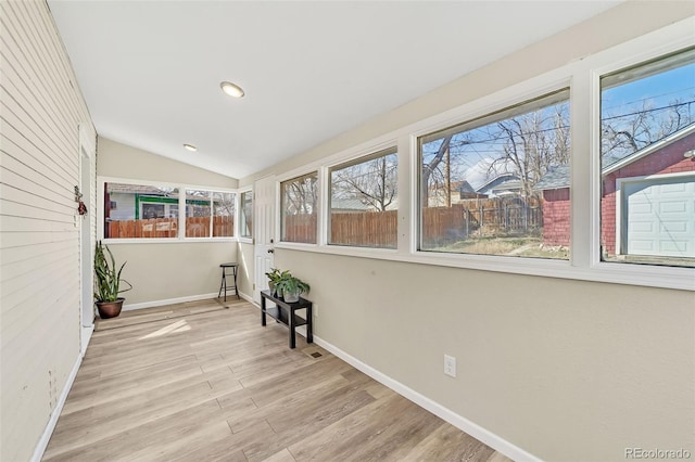 unfurnished sunroom with vaulted ceiling