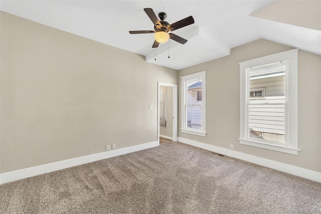 carpeted spare room featuring visible vents, baseboards, lofted ceiling, and ceiling fan