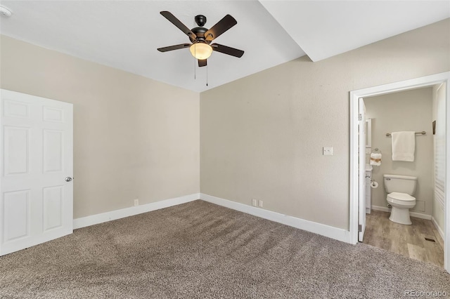 unfurnished bedroom featuring ceiling fan, carpet flooring, baseboards, and connected bathroom