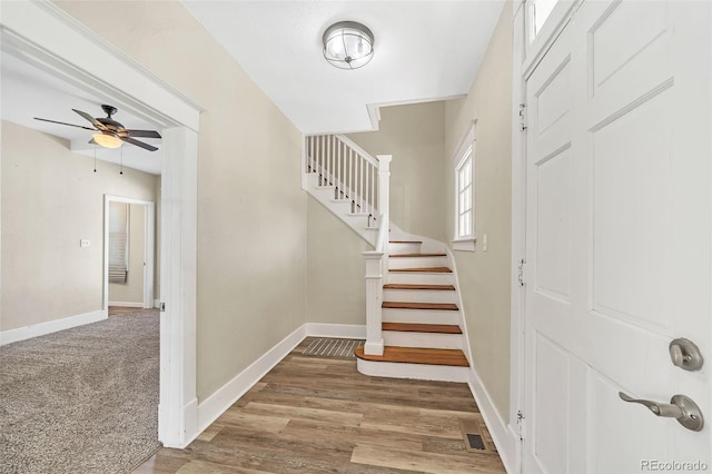 entrance foyer featuring stairs, wood finished floors, baseboards, and a ceiling fan