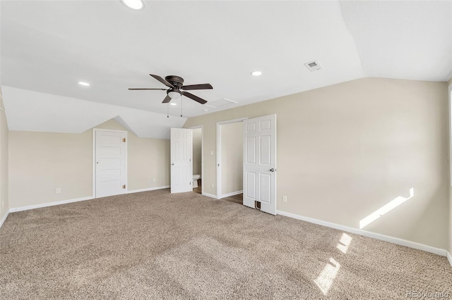 additional living space with visible vents, recessed lighting, carpet floors, baseboards, and vaulted ceiling