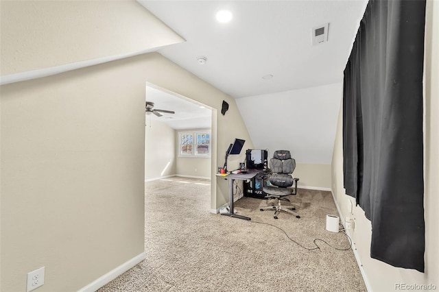 carpeted home office featuring visible vents, baseboards, and vaulted ceiling